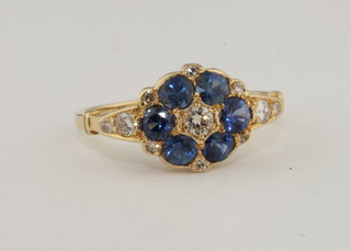 A lady's 18ct yellow gold cluster ring set sapphires and diamonds