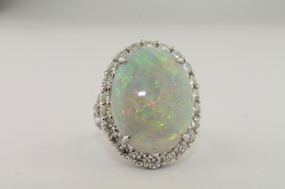 A lady's 18ct white gold dress ring set an oval opal approx 9ct surround by diamonds approx 2ct