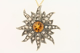 A lady's star shaped pendant set diamonds hung on a fine gold chain