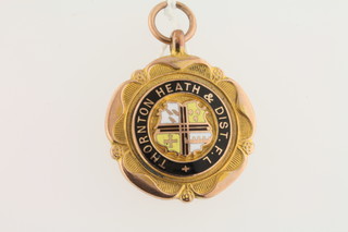 A 9ct gold and enamel watch chain medallion marked Thornton  Heath District