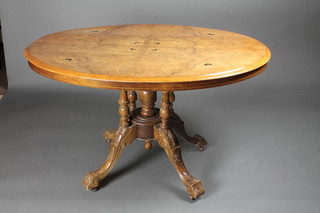 A Victorian inlaid oval figured walnut Loo table raised on 4  turned columns 46"w x 48"h