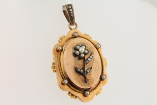 An oval gilt metal locket set pearls