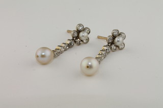 A pair of pearl and diamond drop earrings