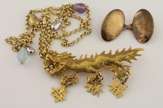 An oval 15ct gold cufflink, an Oriental gilt metal brooch and a gilt metal necklet hung coloured stones