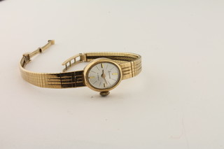 A lady's Accurist gold wristwatch with integral gold strap