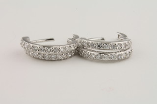 A pair of hoop earrings set diamonds