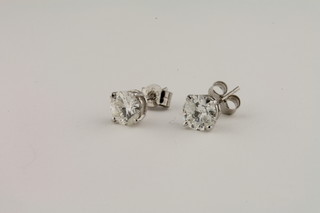 A pair of 14ct white gold diamond stud earrings, approx 1.18ct