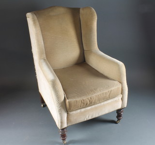 A winged armchair upholstered in mushroom material