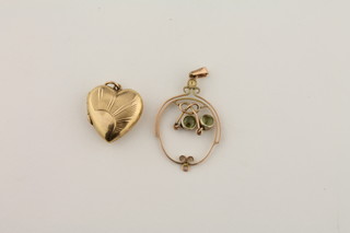 A gilt metal heart shaped locket and a pierced gilt metal pendant  set blue stones