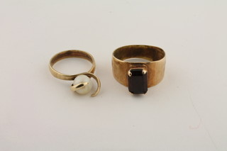 A 9ct gold dress ring set a pearl and a gold dress ring set a rectangular cut red stone