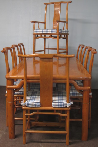 An Oriental hardwood dining suite comprising rectangular dining table raised on turned supports 78"w x 39"d x 31 1/2"h together  with 8 dining chairs - 2 carvers, 6 standard