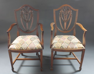 A pair of mahogany Hepplewhite style carver chairs with  upholstered drop in seats, raised on square tapering supports