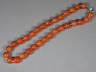 A string of amber coloured hardstone beads