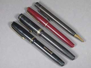 A red Parker 17 Lady fountain pen, a black Burnham B48  fountain pen and a propelling pencil