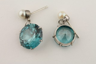 A pair of circular blue glass coloured drop earrings