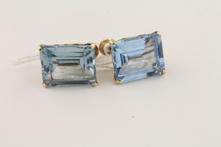 A pair of 9ct yellow gold earrings set rectangular cut blue stones