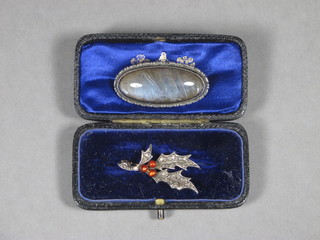 A brooch in the form of a sprig of holly and an oval silver  brooch set butterfly wings