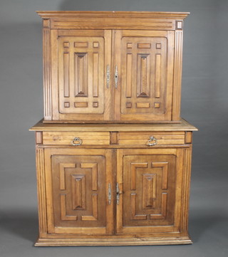 A French walnut cabinet on cabinet, the upper section with  moulded cornice, the interior fitted shelves enclosed by panelled  doors, the base fitted 2 drawers above a double cupboard, raised  on a moulded platform base 48"w x 19"d x 69 1/2"h