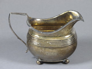 A Georgian silver cream jug, London 1809, marks rubbed 5 ozs