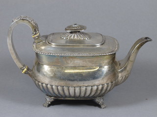 A Georgian silver teapot of cushion form with demi-reeded  decoration, London 1817, 21 1/2 ozs