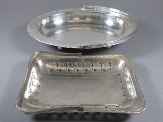 An oval silver plated cake basket with swing handle and a rectangular silver plated cake basket