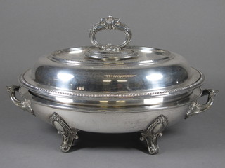 An oval silver plated entree dish and cover and a silver plated dish