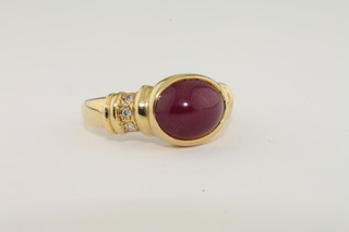 A 14ct gold dress ring set an oval cabouchon cut red stone