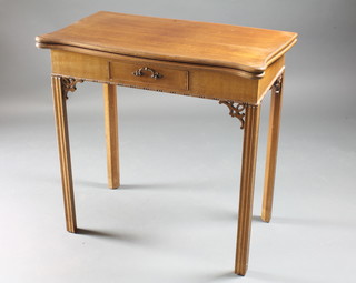 An Edwardian Chippendale style bleached mahogany card table  of serpentine outline, fitted a frieze drawer and raised on square  tapering supports 30"w x 16 1/2"d x 29" 1/2"h