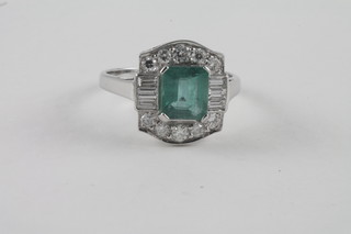 A lady's 18ct white gold dress ring set a rectangular cut emerald surrounded by diamonds approx 2ct/0.80ct