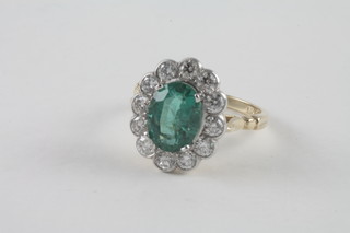 A lady's 18ct yellow gold dress ring set an oval emerald  surrounded by diamonds approx 2.40/1.05ct