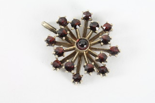 A gilt metal star shaped pendant set garnets