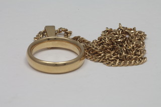 A 22ct gold wedding band hung on a gold chain