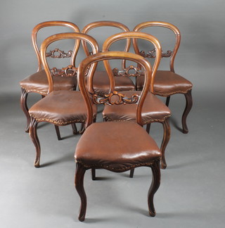 A set of 6 Victorian mahogany balloon back dining chairs, the seats of serpentine outline, raised on cabriole supports with  carved mid rails