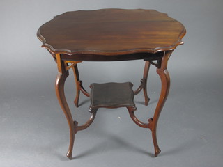 An Edwardian serpentine shaped 2 tier occasional table, raised on cabriole supports 30"w x 23"d x 27"h