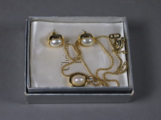 A Christian Dior necklace, a pair of gilt metal necklets set a "pearl" and a pair of earrings
