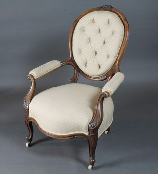 A Victorian walnut show frame open arm chair upholstered in  yellow buttoned material, raised on cabriole supports