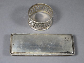 A rectangular silver dressing table jar lid, Birmingham 1921 4", together with a silver napkin ring Birmingham 1937, 2 ozs