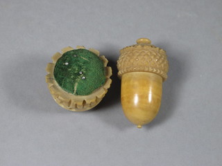 A Victorian carved ivory thimble case in the form of an acorn  containing a thimble 2" and a circular carved ivory pin cushion  1"
