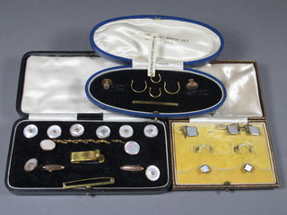 4 9ct and 18ct studs together with 2 other studs, a set of 6 9ct and  mother of pearl finished dress studs and matching cufflinks and 2  9ct gold studs, cased