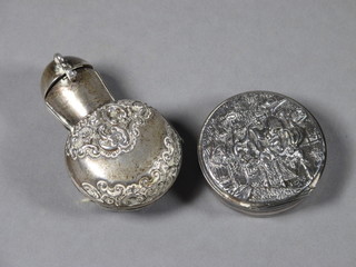 A circular Danish embossed white metal pill box with hinged lid 1/2" and a similar embossed scent bottle, cased, 2"