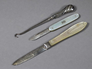 A Victorian silver bladed folding fruit knife with mother of pearl  grip Sheffield 1847, 1 other and a button hook