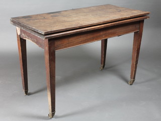 A rectangular Georgian mahogany tea table, raised on square tapering supports ending in brass caps and castors 22"w x 30"h