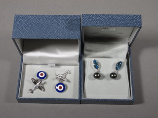 A pair of silver and enamelled cufflinks in the form of Spitfires with RAF roundels together with a pair of earrings