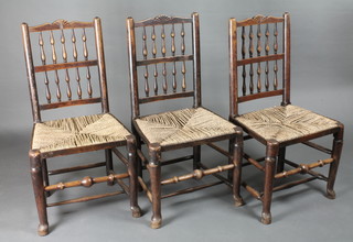 A set of 3 18th/19th Century elm spindle back dining chairs with woven rush seats, raised on club supports