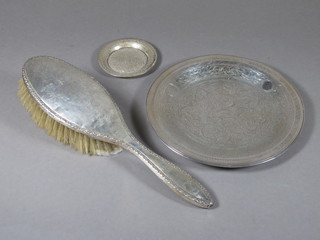 An embossed silver backed hand mirror and 2 Eastern white  metal dishes 7" and 3"