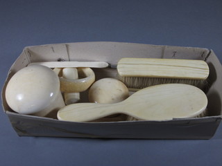 An ivory jar and cover - cracked, 1 other jar and cover, a bangle,  a cylindrical needle case and a 4 piece ivory backed dressing  table set