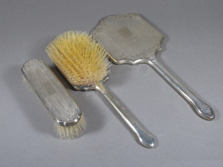 A 3 piece silver backed dressing table set comprising hair brush, hand mirror and clothes brush, Birmingham 1953 with  Coronation hallmark