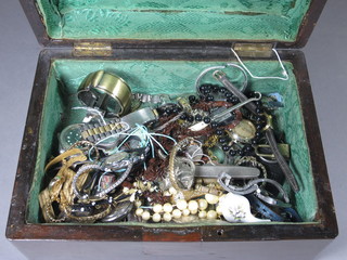 A wooden box containing costume jewellery
