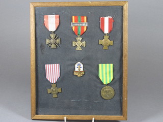 A French Croix de Guerre, a French combat cross, an Indo  China medal, 2 other French medals and a badge