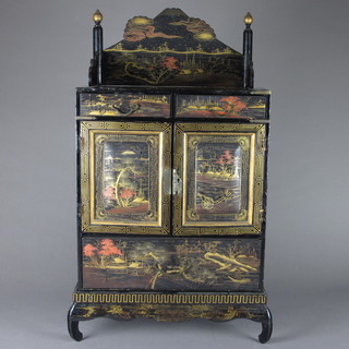 An Oriental lacquered table top cabinet with three-quarter gallery fitted 2 short drawers, the interior fitted 6 short drawers enclosed  by panelled doors, the base fitted 1 long drawer 17"w x 9 1/2"d  x 28 1/2"h
